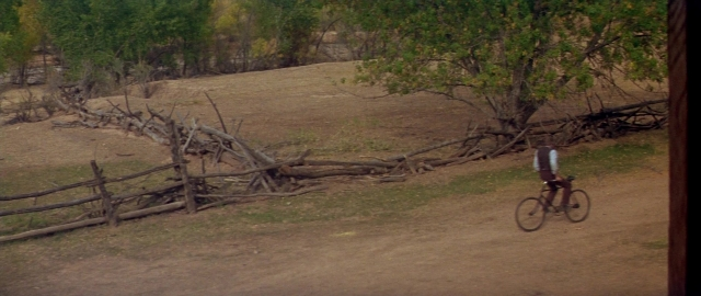 Wide shot frame from Butch Cassidy and the Sundance Kid — street, bicycle, shirt