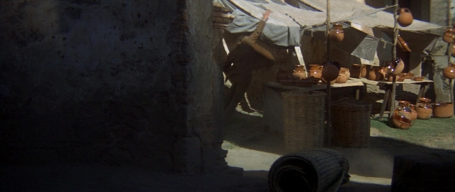 Wide shot frame from Butch Cassidy and the Sundance Kid — standing, hat, coat