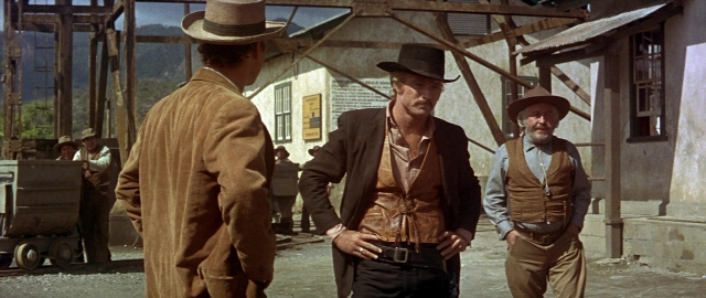 Wide shot frame from Butch Cassidy and the Sundance Kid — standing, dialogue, hat
