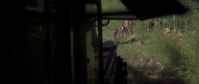Wide shot frame from Butch Cassidy and the Sundance Kid — walking, train, forest