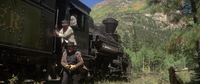 Wide shot frame from Butch Cassidy and the Sundance Kid — standing, door, hat