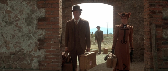 Wide shot frame from Butch Cassidy and the Sundance Kid — standing, hat, coat