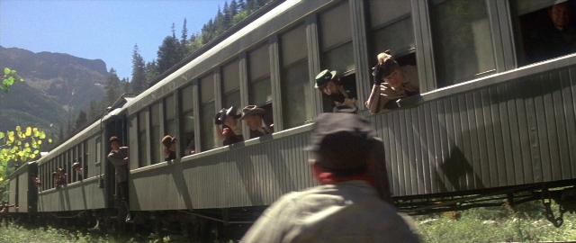 Wide shot frame from Butch Cassidy and the Sundance Kid — standing, hat, car