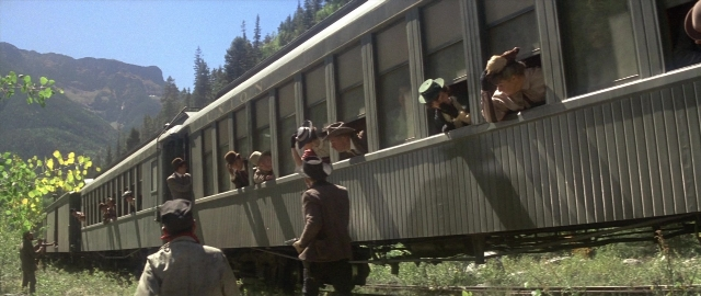 Wide shot frame from Butch Cassidy and the Sundance Kid — standing, car, train