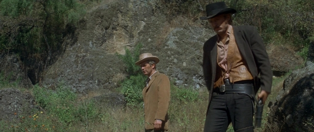 Wide shot frame from Butch Cassidy and the Sundance Kid — standing, hat, coat