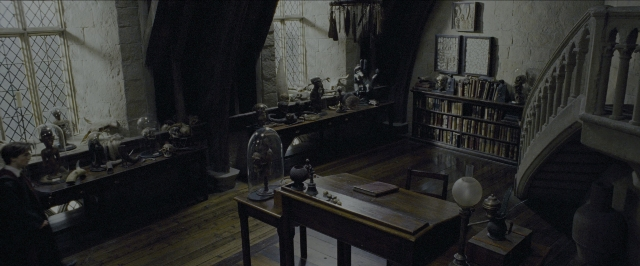 Wide shot frame from Harry Potter and the Prisoner of Azkaban — sitting, book, room