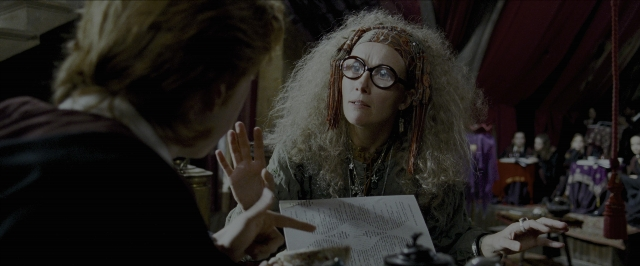 Wide shot frame from Harry Potter and the Prisoner of Azkaban — sitting, standing, table