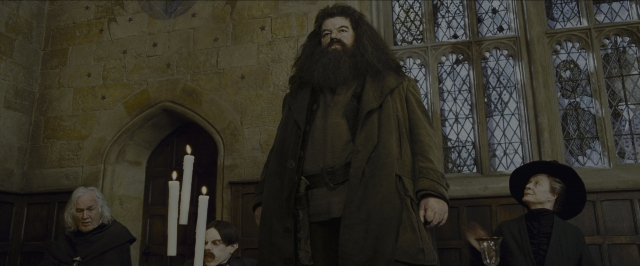 Wide shot frame from Harry Potter and the Prisoner of Azkaban — sitting, book, standing