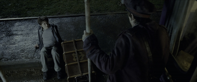 Wide shot frame from Harry Potter and the Prisoner of Azkaban — sitting, car, hand