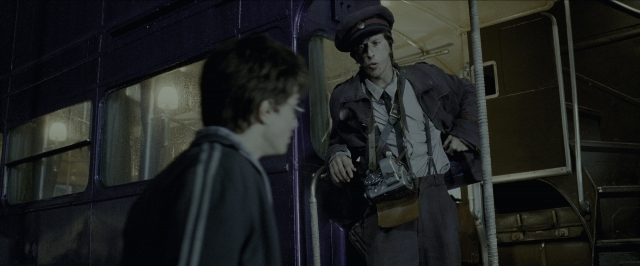 Wide shot frame from Harry Potter and the Prisoner of Azkaban — standing, hat, hand