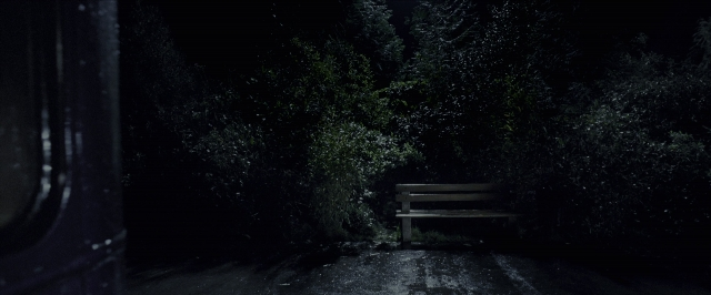 Wide shot frame from Harry Potter and the Prisoner of Azkaban — sitting, bench, forest
