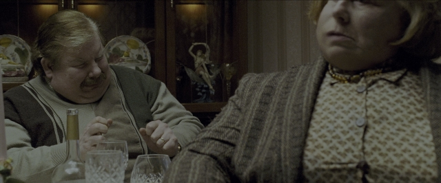 Wide shot frame from Harry Potter and the Prisoner of Azkaban — sitting, table, shirt