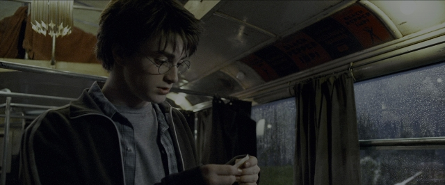 Wide shot frame from Harry Potter and the Prisoner of Azkaban — standing, phone, car