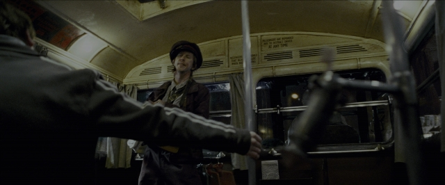 Wide shot frame from Harry Potter and the Prisoner of Azkaban — sitting, standing, hat