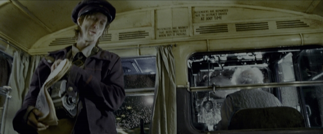Wide shot frame from Harry Potter and the Prisoner of Azkaban — sitting, book, standing
