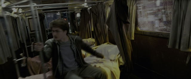 Wide shot frame from Harry Potter and the Prisoner of Azkaban — sitting, bed, street