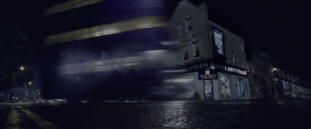 Wide shot frame from Harry Potter and the Prisoner of Azkaban — street, night, restaurant