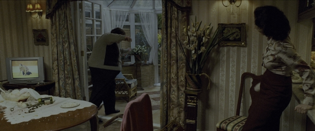 Wide shot frame from Harry Potter and the Prisoner of Azkaban — sitting, standing, room