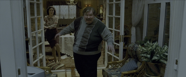 Wide shot frame from Harry Potter and the Prisoner of Azkaban — standing, room, door