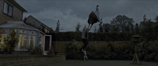 Wide shot frame from Harry Potter and the Prisoner of Azkaban — standing, dog, house
