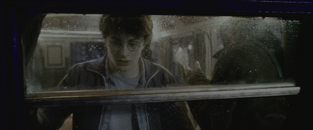 Wide shot frame from Harry Potter and the Prisoner of Azkaban — sitting, face, train