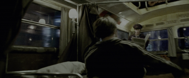 Wide shot frame from Harry Potter and the Prisoner of Azkaban — sitting, book, bed