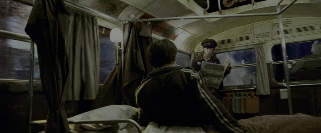 Wide shot frame from Harry Potter and the Prisoner of Azkaban — sitting, bed, hat