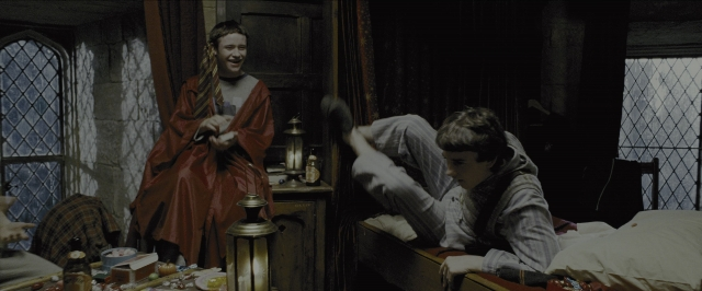 Wide shot frame from Harry Potter and the Prisoner of Azkaban — book, table, bed