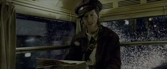 Wide shot frame from Harry Potter and the Prisoner of Azkaban — sitting, hat, face