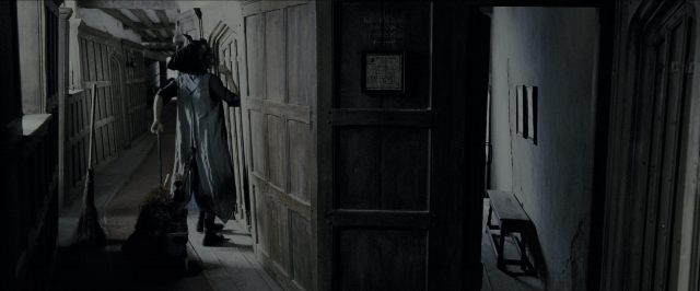 Wide shot frame from Harry Potter and the Prisoner of Azkaban — standing, door, hat