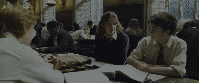 Wide shot frame from Harry Potter and the Prisoner of Azkaban — sitting, book, room