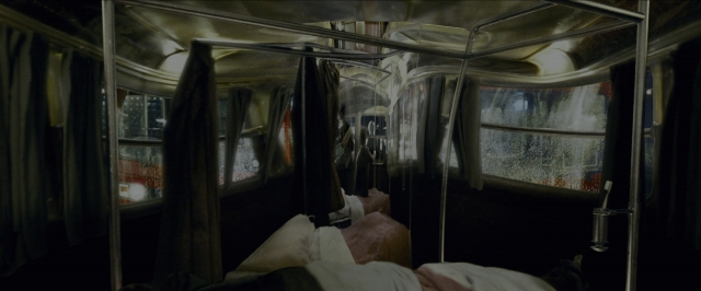 Wide shot frame from Harry Potter and the Prisoner of Azkaban — bed, bus, person