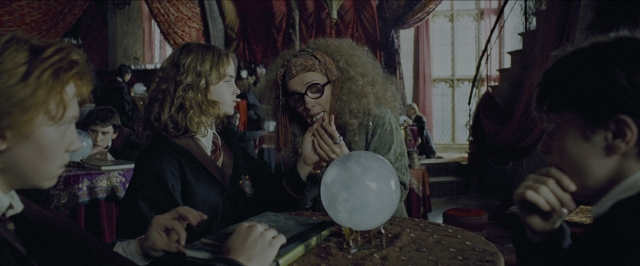 Wide shot frame from Harry Potter and the Prisoner of Azkaban — sitting, book, room