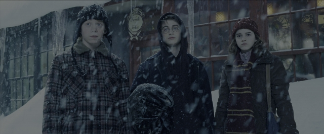 Wide shot frame from Harry Potter and the Prisoner of Azkaban — standing, coat, bag