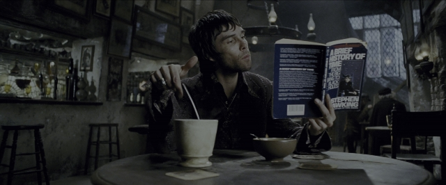 Wide shot frame from Harry Potter and the Prisoner of Azkaban — sitting, book, table