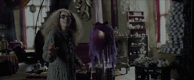 Wide shot frame from Harry Potter and the Prisoner of Azkaban — standing, room, table