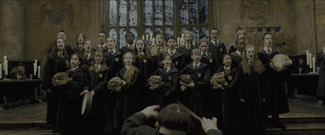 Wide shot frame from Harry Potter and the Prisoner of Azkaban — standing, glass, person