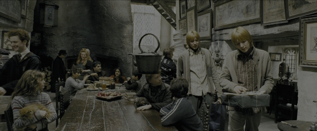 Wide shot frame from Harry Potter and the Prisoner of Azkaban — sitting, book, standing