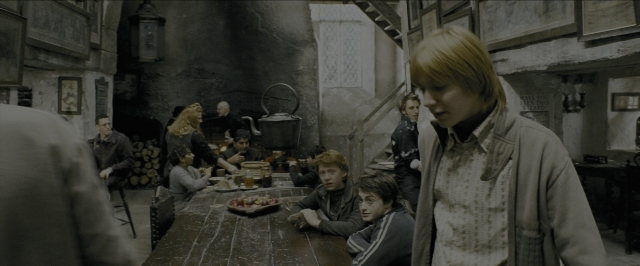 Wide shot frame from Harry Potter and the Prisoner of Azkaban — sitting, standing, room