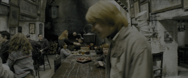 Wide shot frame from Harry Potter and the Prisoner of Azkaban — sitting, standing, room