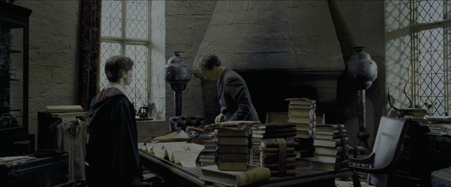 Wide shot frame from Harry Potter and the Prisoner of Azkaban — standing, room, table