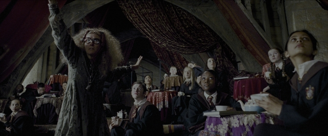 Wide shot frame from Harry Potter and the Prisoner of Azkaban — sitting, standing, room