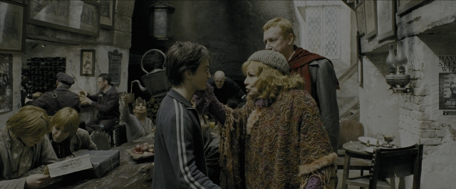Wide shot frame from Harry Potter and the Prisoner of Azkaban — sitting, book, standing