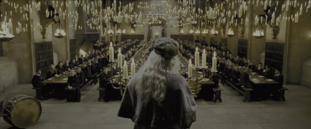 Wide shot frame from Harry Potter and the Prisoner of Azkaban — sitting, standing, room