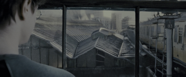 Wide shot frame from Harry Potter and the Prisoner of Azkaban — standing, shirt, train