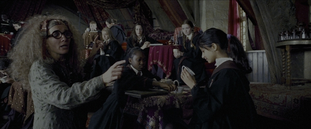 Wide shot frame from Harry Potter and the Prisoner of Azkaban — sitting, book, room