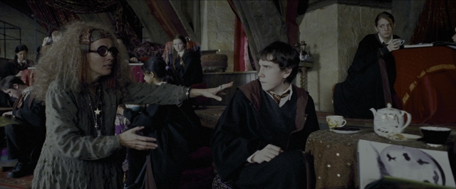 Wide shot frame from Harry Potter and the Prisoner of Azkaban — sitting, book, room