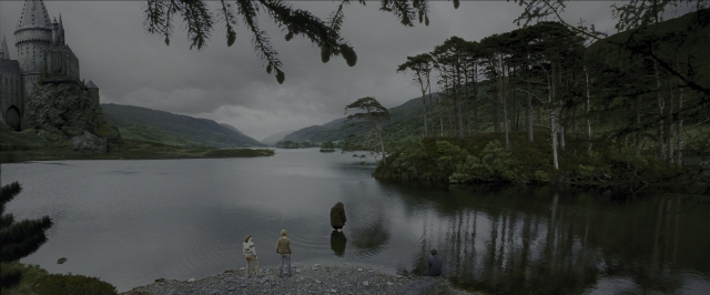 Wide shot frame from Harry Potter and the Prisoner of Azkaban — standing, water, castle