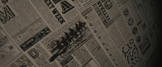 Wide shot frame from Harry Potter and the Order of the Phoenix — newspaper, horse, poster