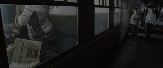 Wide shot frame from Harry Potter and the Order of the Phoenix — sitting, standing, car